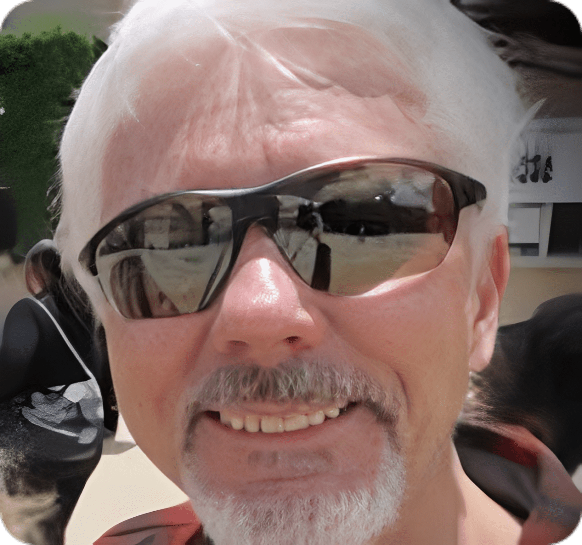 Smiling man with white hair and sunglasses